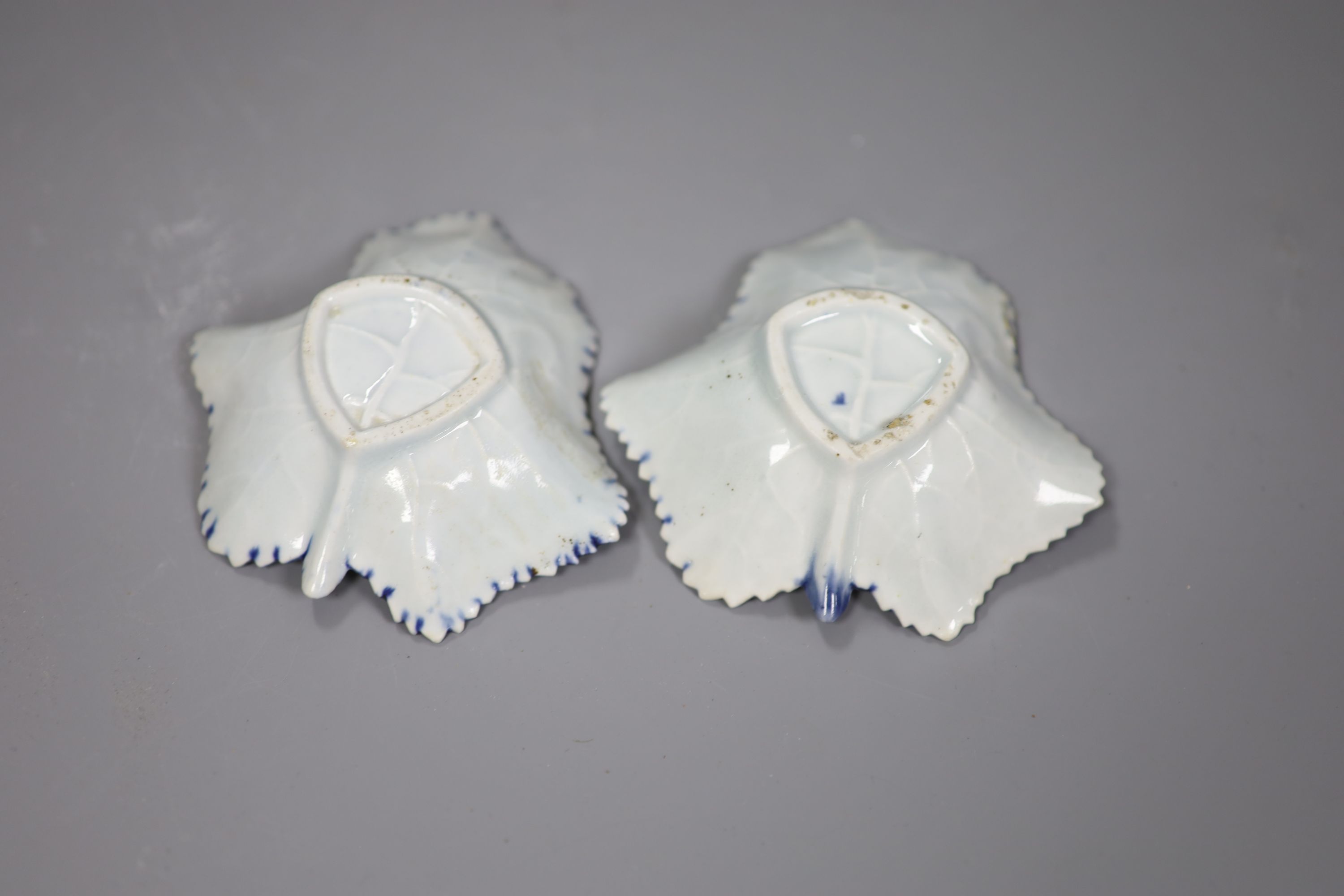 An 18th century Worcester pair of leaf-shaped pickle dishes painted in underglaze blue with a fruiting vine, one with workmans mark.